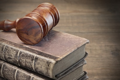 Wooden Judges Gavel And Old Law Books On Wooden Background