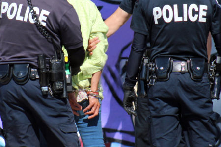 editorial photograph: up close arrest of homeless woman